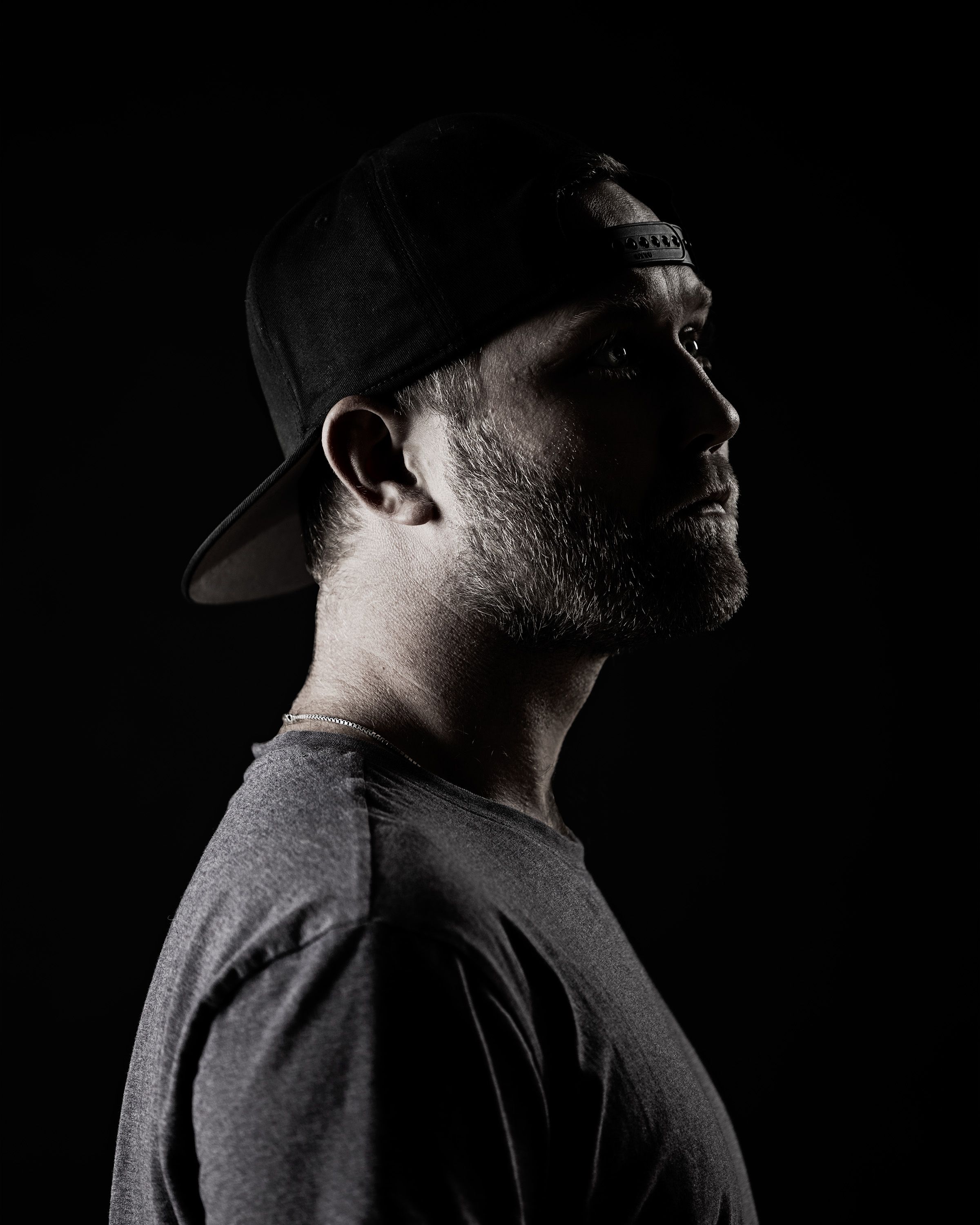 Split-light studio self-portrait of photographer Cary Ellis