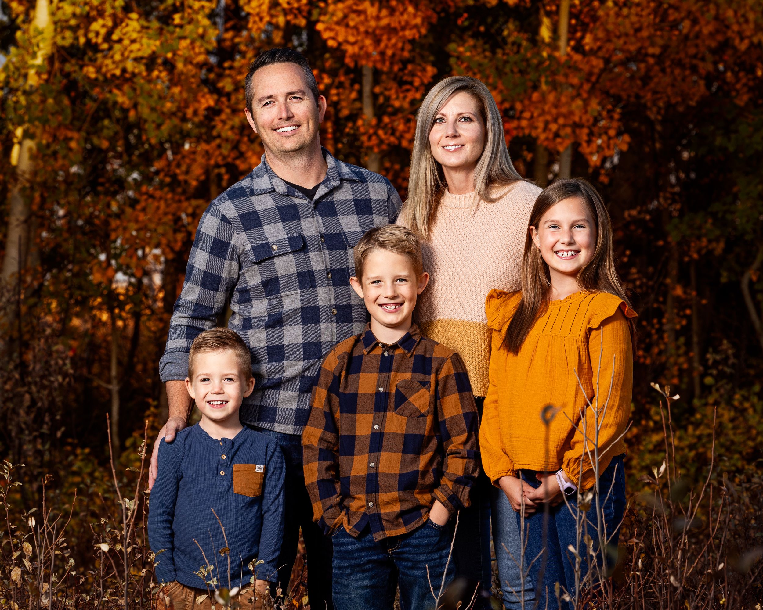 Family photographed outdoors at golden hour