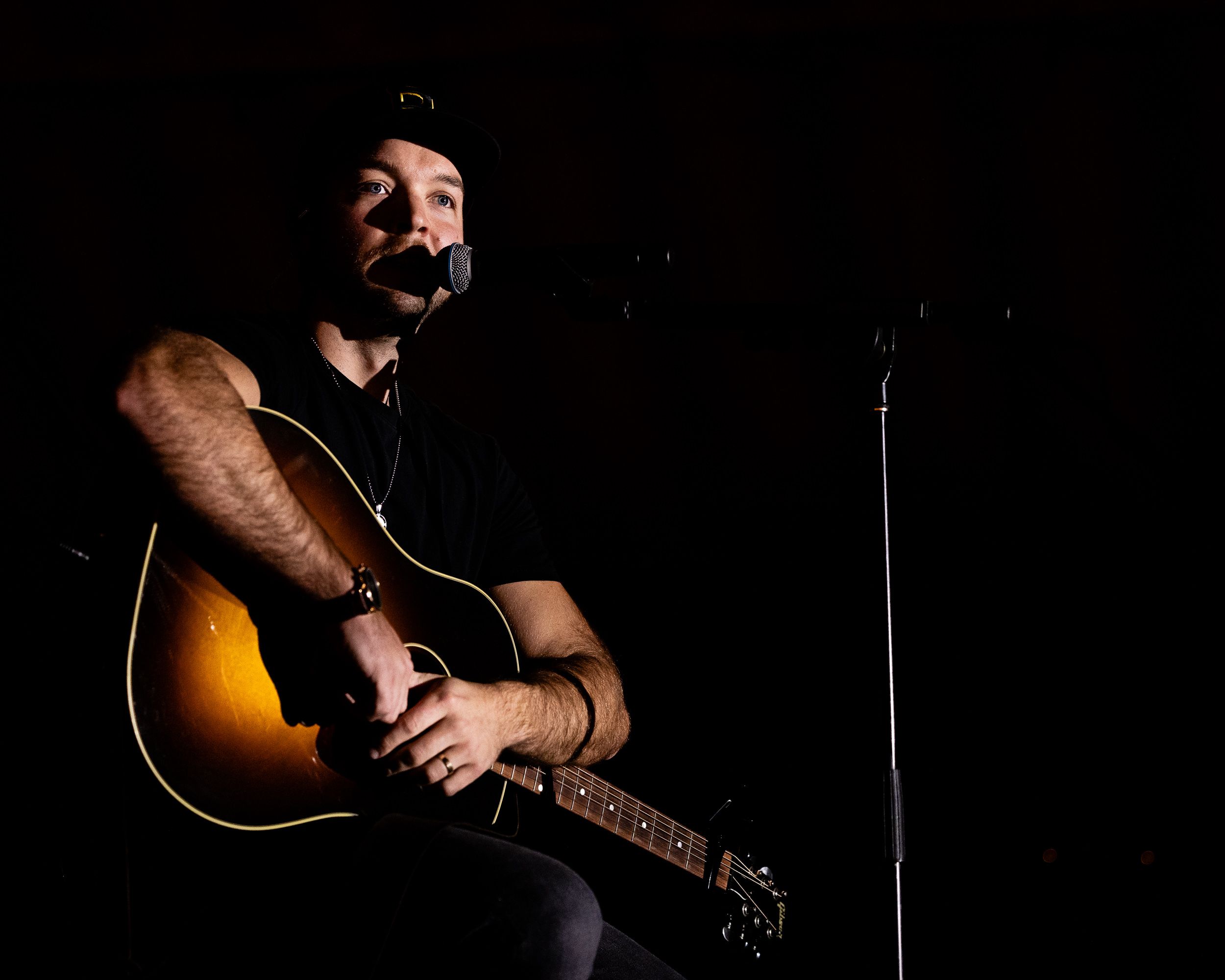 Guitarist in a spotlight at an album release show