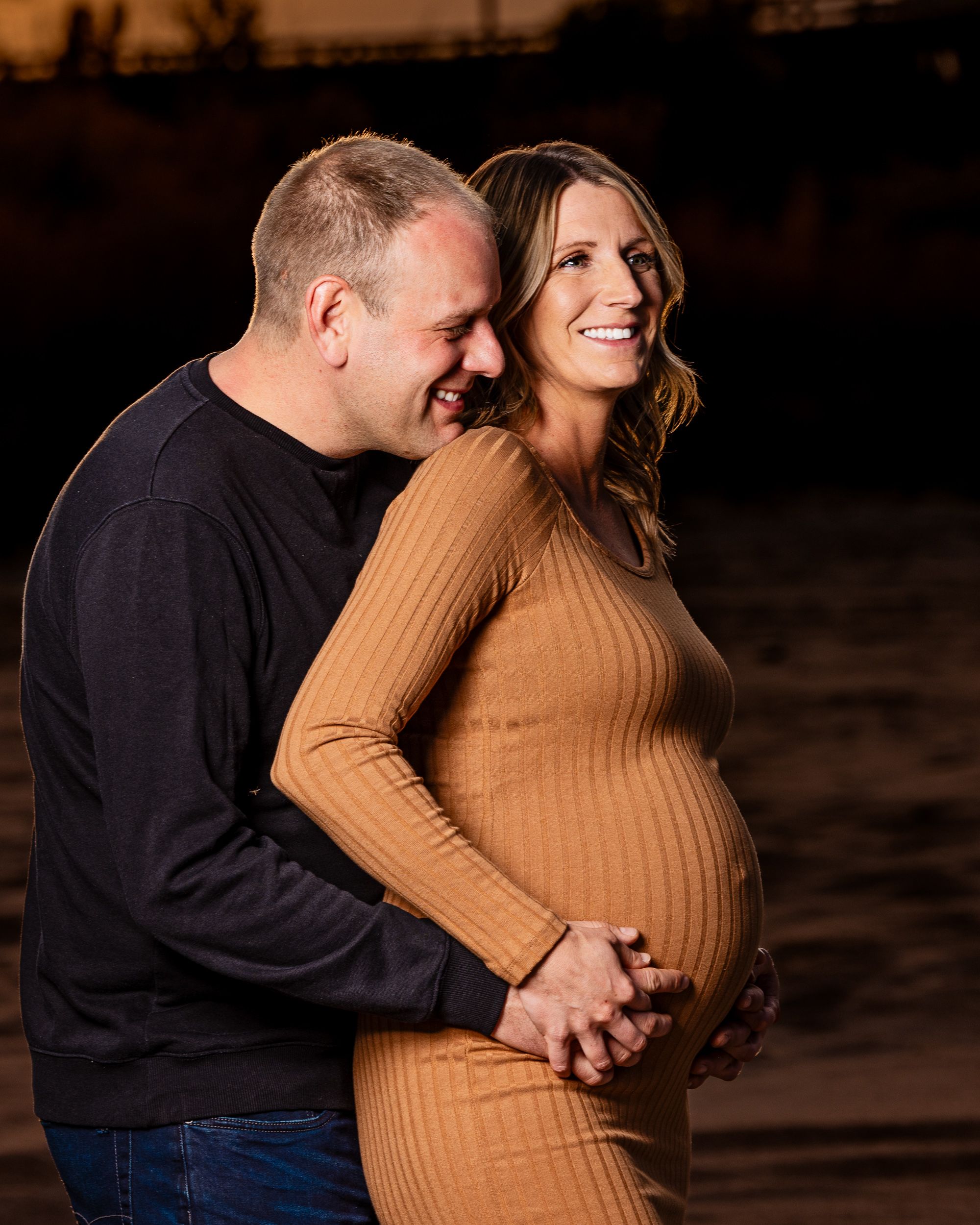Maternity portrait in an open field at sunset
