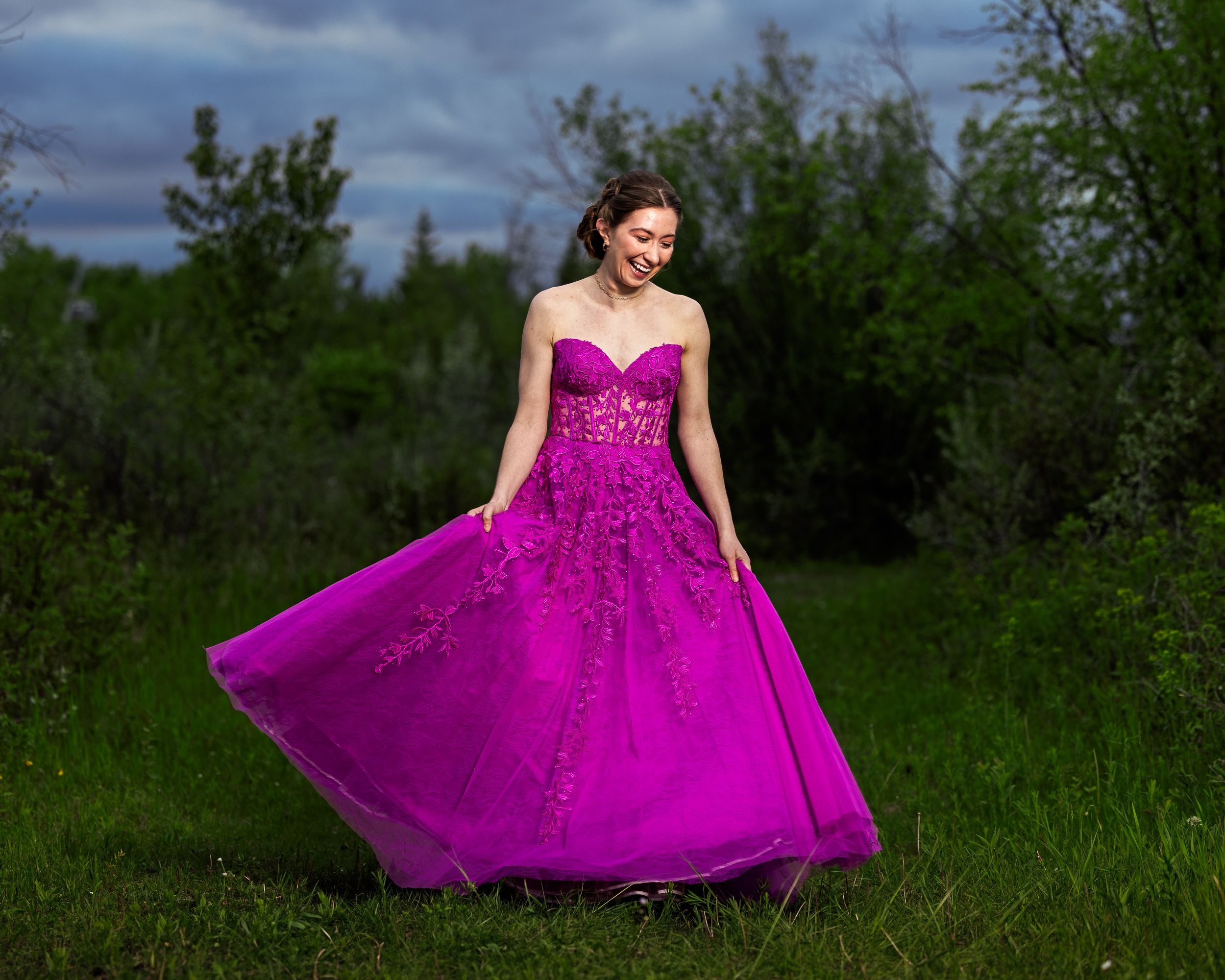 Grad in a magenta dress in green prairie brush