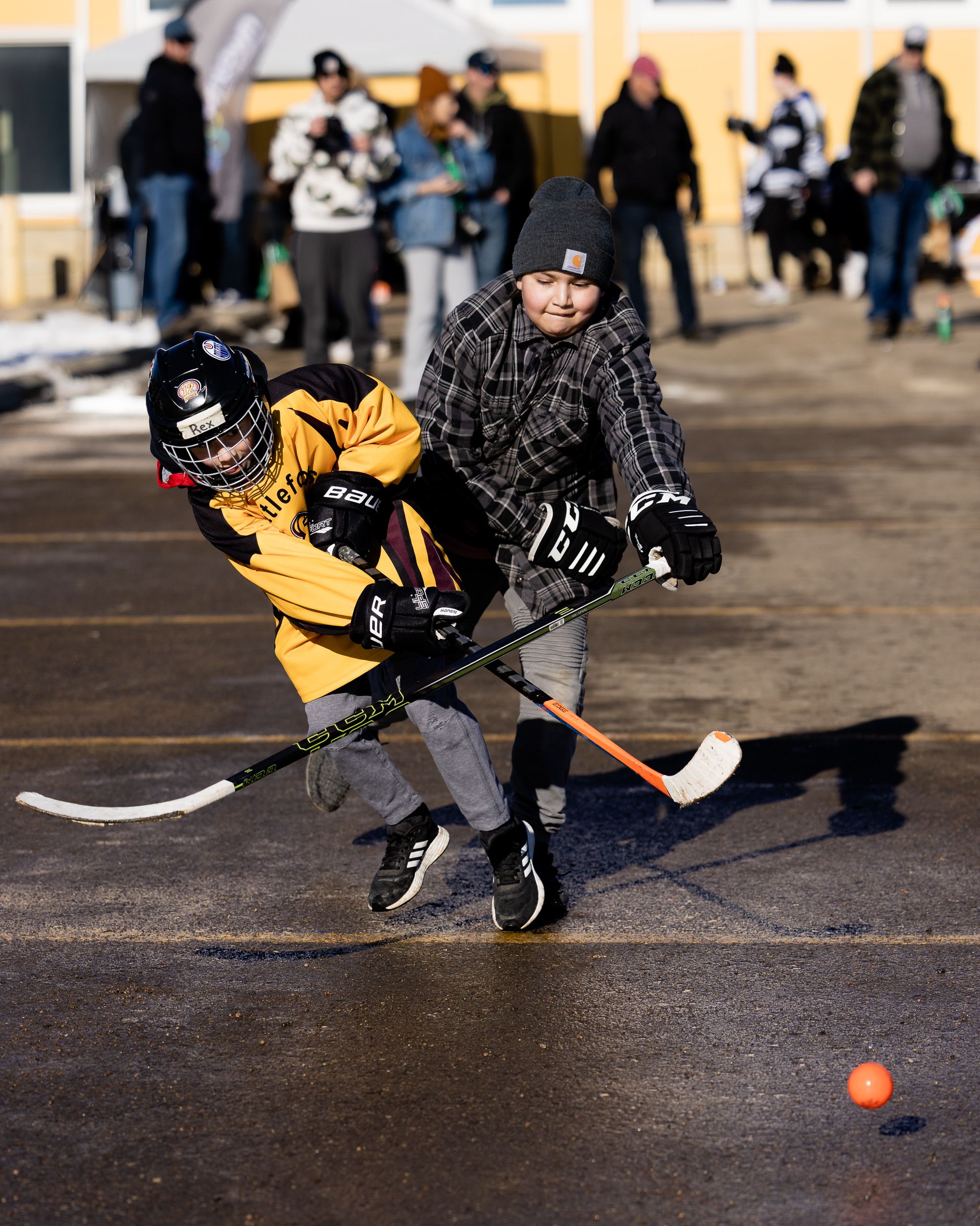 Kids playing street hockey at golden hour