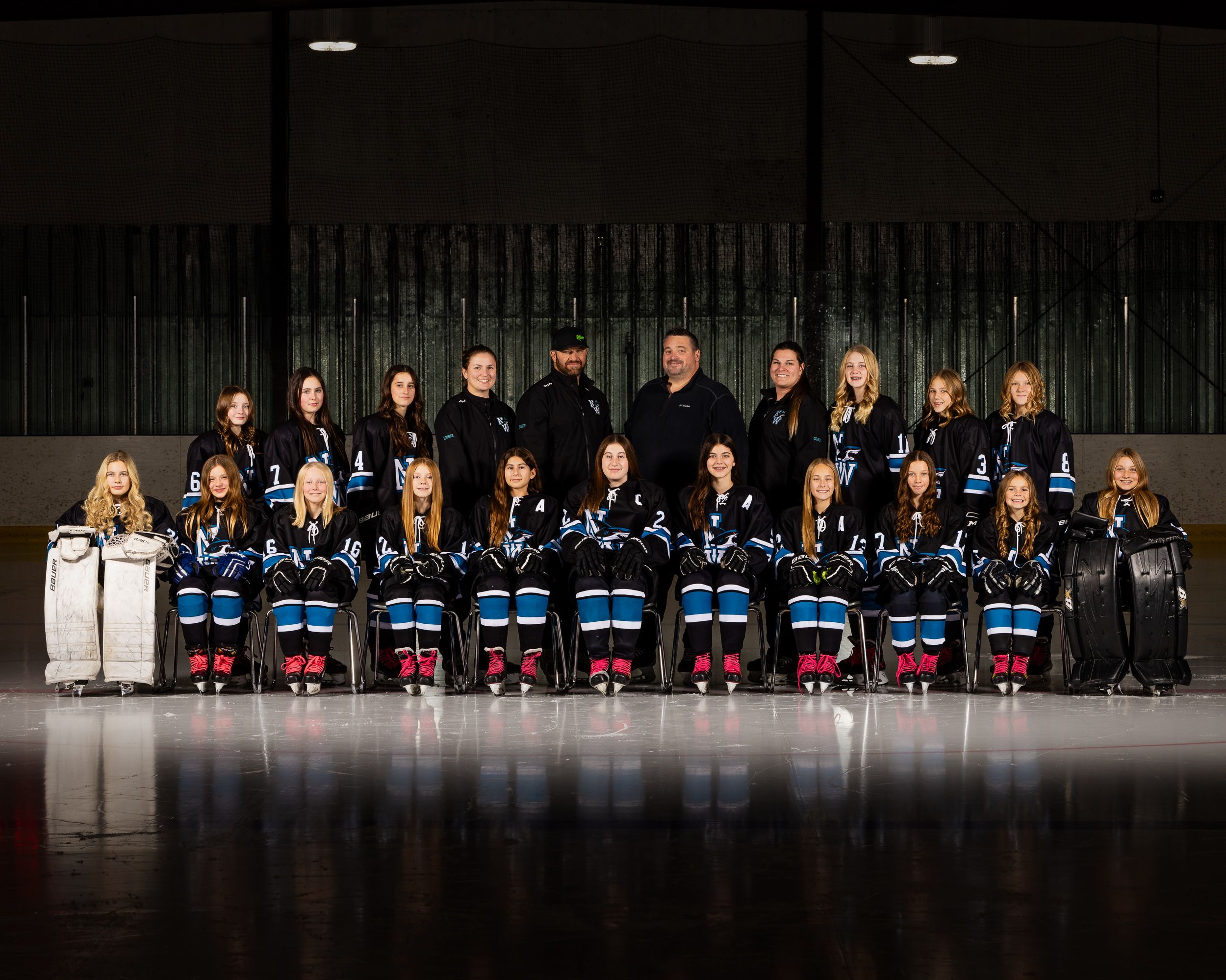 U13 AA Sharks team portrait on dark arena ice
