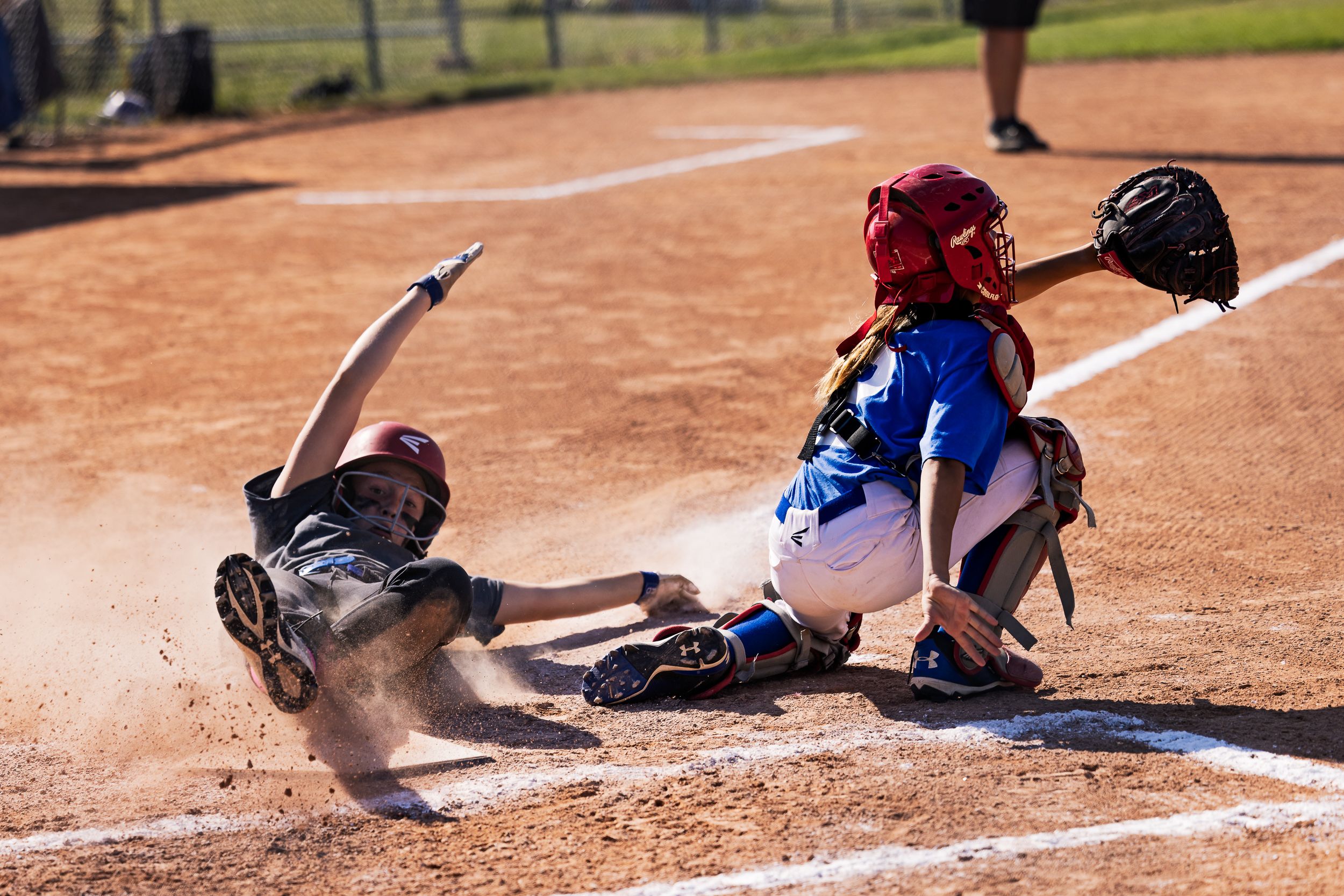 U13 softball player in gritty action on the diamond