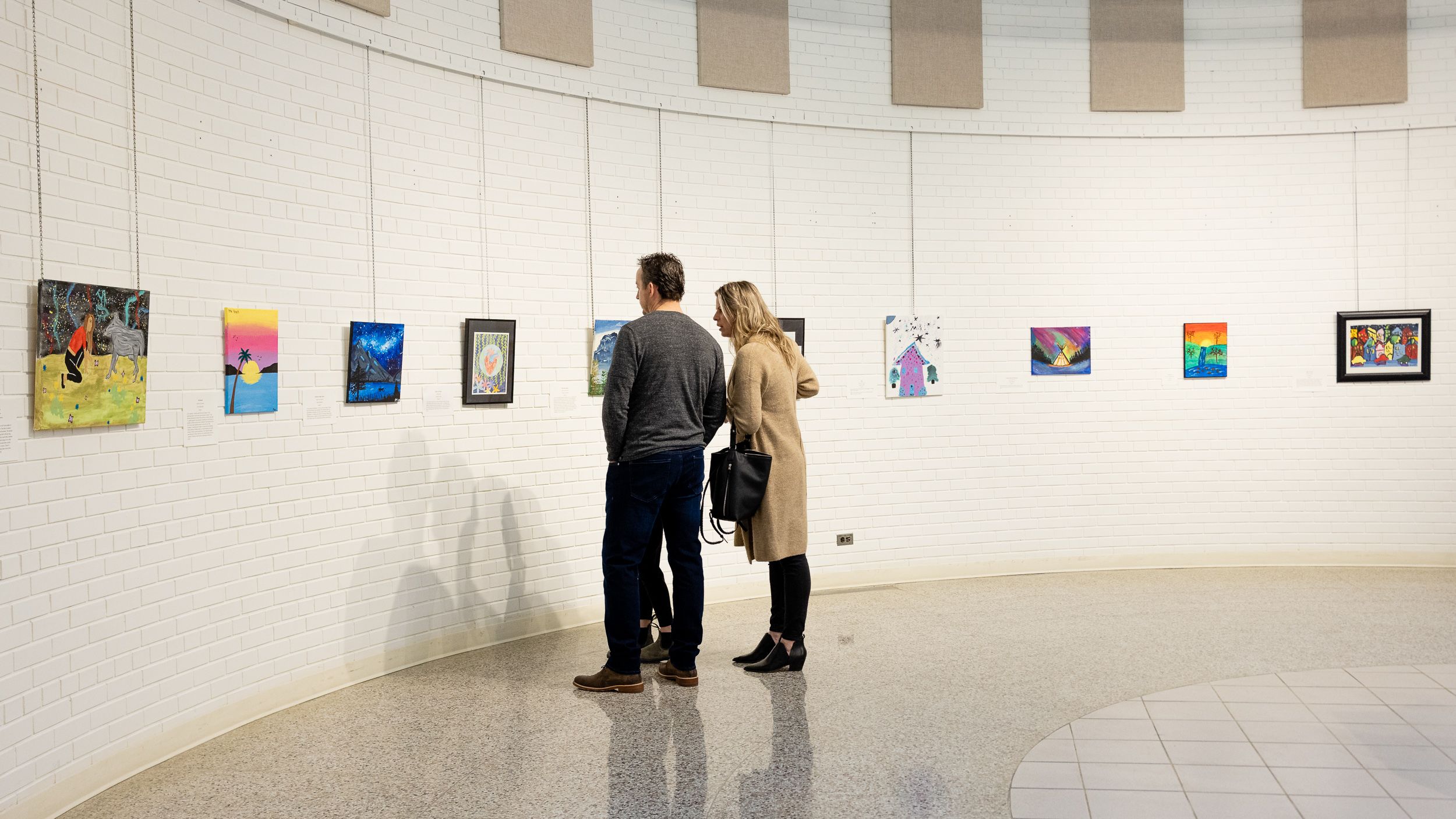 Visitors viewing artwork in the gallery at the Hazee Youth Art Competition
